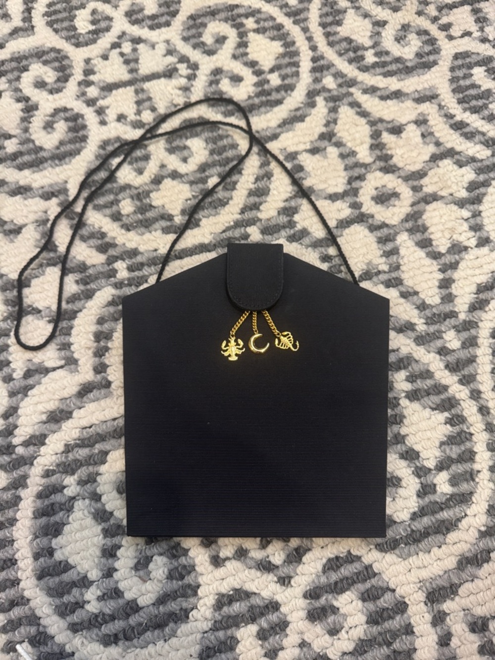 Scepi Black Crossbody Pouch with Gold Charm Accents